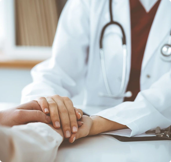 Doctor holding patient’s hand